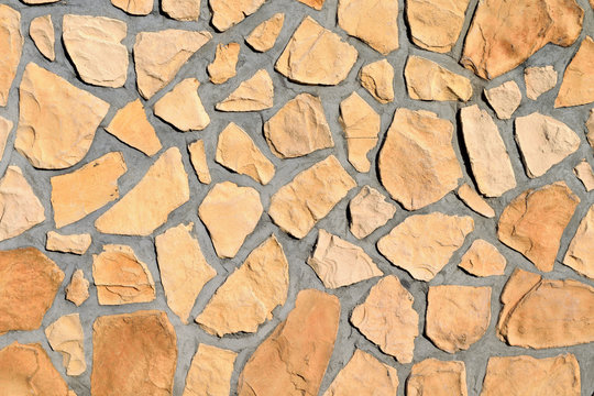 Texture, Surface of wall made of cement and yellow stone