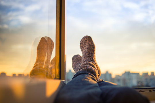 Men's feet in socks on relaxation window