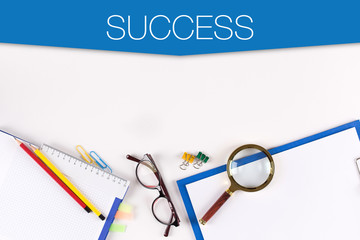 High Angle View of Various Office Supplies on Desk with a word SUCCESS