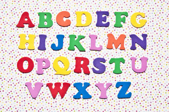 colorful alphabet letters, a to z over jolly background with pola dots in various colors