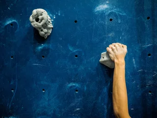 Fotobehang sport woman hanging extreme sport climbing wall in indoor gym © anusak