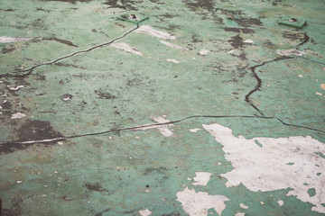 Grunge green concrete cement floor with crack in industrial building.