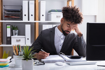 Unhappy Businessman Working In Office