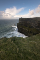 Fototapeta na wymiar The Cliffs of Moher winds whip around at sunset, Co. Clare, Ireland.