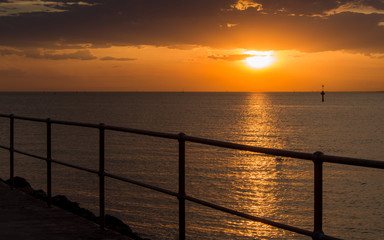 Scenic sunset from pier above the sea