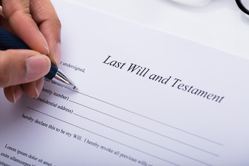 Person Filling Last Will And Testament Form