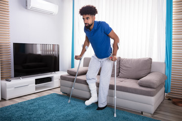 Man With Broken Leg Walking On Carpet