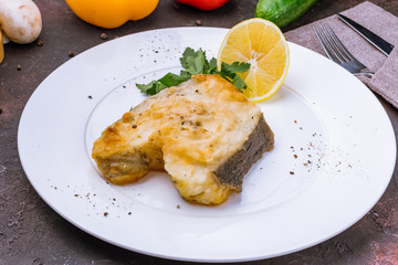 Halibut steak on a white plate