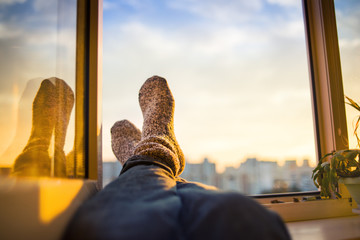 Men's feet in socks on relaxation window