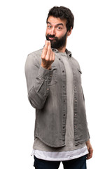 Fototapeta premium Handsome man with beard making money gesture on white background