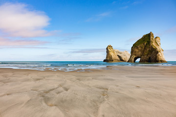 New Zealand wharariki beach and arch island rock formations - 189750331