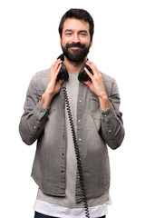 Fototapeta premium Handsome man with beard listening music on white background