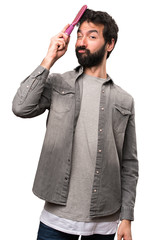 Fototapeta premium Handsome man with beard and with hair comb on white background