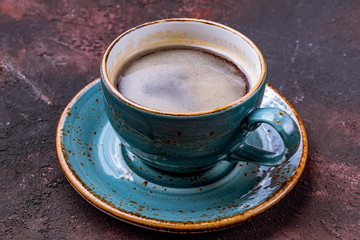 Cup of coffee on a rusty background