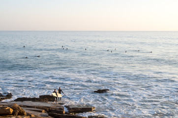 Two surfers going into the ocean in Taghazout - Panoramas surf spot.