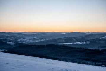 daylight from Ochodzita hill in winter Beskid Slaski mountains above Koniakow village in Poland with clear sky