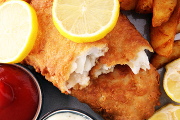 traditional British fish and chips with potato and lemon
