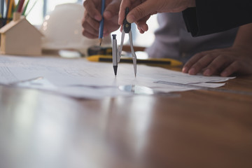 Architect working on real estate project with partner at workplace. engineer discussing with colleague on house blueprint at office. Business, people, construction and building concept
