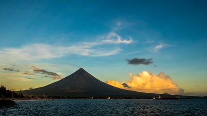 Fototapeta na wymiar Silhouette Mayon Volcano is an active stratovolcano in the province of Albay in Bicol Region, on the island of Luzon in the Philippines. Renowned as the perfect cone because of its symmetric conical