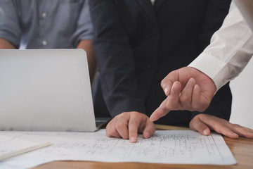 Architect working on real estate project with partner at workplace. engineer discussing with colleague on house blueprint at office. Business, people, construction and building concept