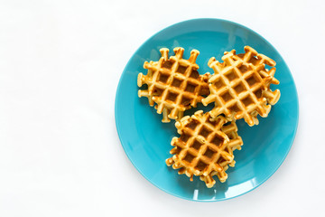 Homemade Belgian waffles on blue plate. Selective focus