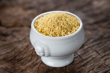Millet grains on wooden background