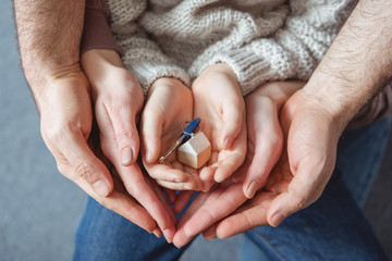 cropped shot of family holding key from new house in hands