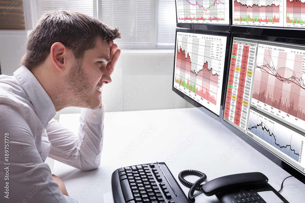 Aufkleber Sad Male Operator Looking At Graphs On Multiple Computer Screen