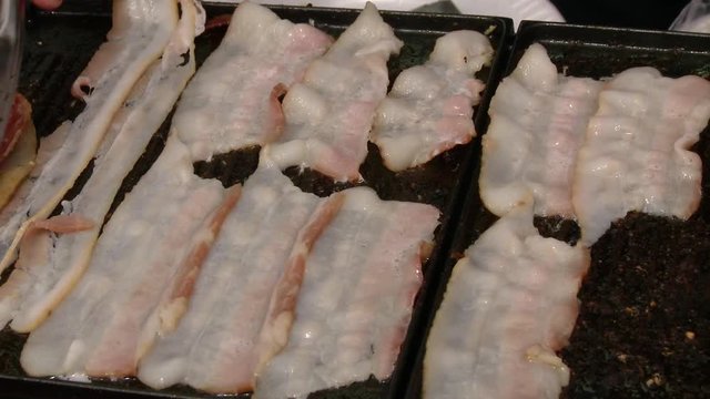 Cooking delicious bacon at food and BBQ festival
