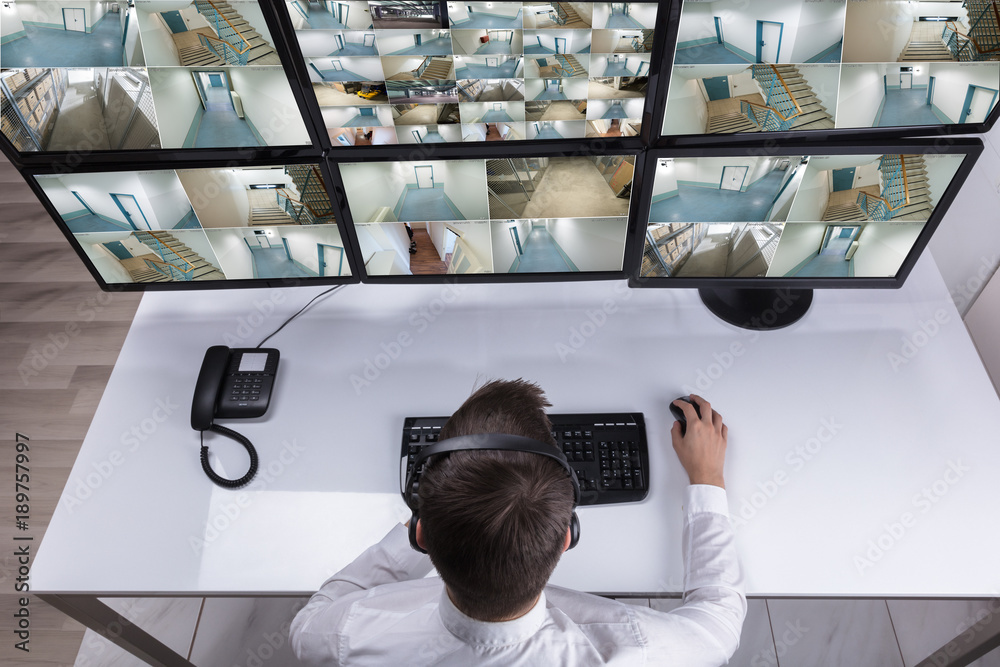 Aufkleber Security Guard Monitoring Multiple Camera Footage On Computer