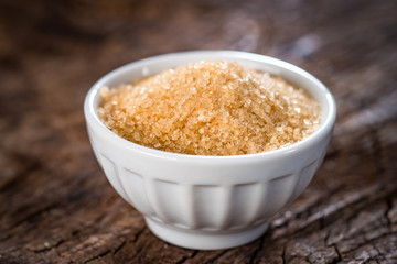 Brown sugar on wooden background