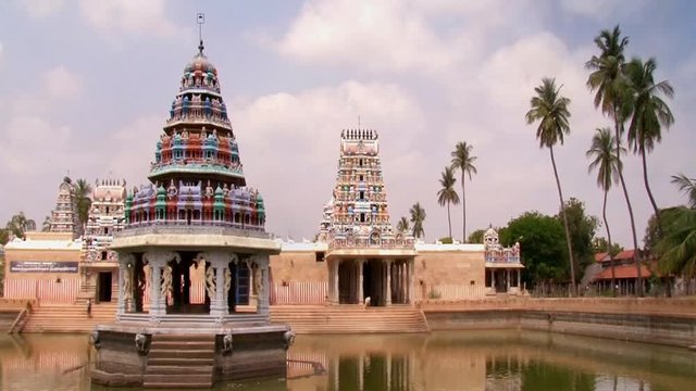 Clouds passing on South Indian Temple background with pond