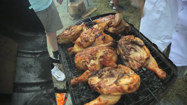 Cook fries chicken carcasses on the grill
