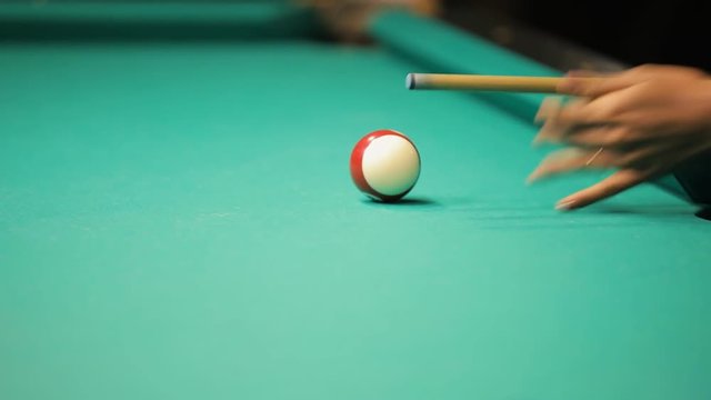 Billiards, concentrated young woman playing in club