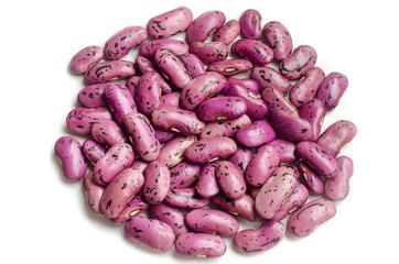 Heap of speckled purple kidney beans on white background