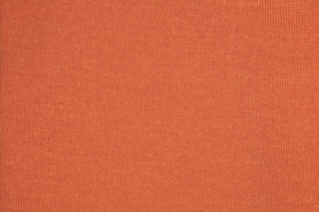 fabric in orange color, close-up on the stitch