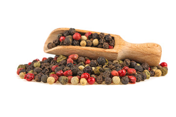 mixture of peppers on a wooden spoon isolated on white background