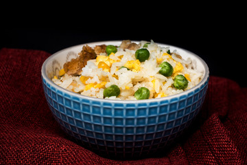 Homemade Chinese fried rice with vegetables and fried eggs