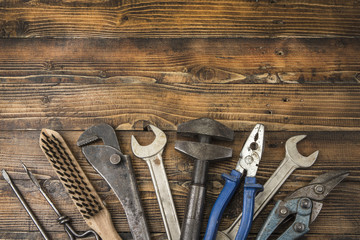 Old different tools on a wooden background with copy space.