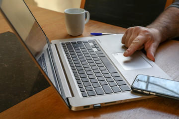 laptop with a hand of a man and a woman