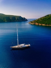 Aerial view to Yacht in deep blue sea.