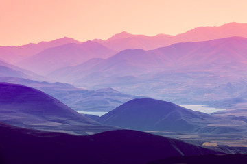 The layered silhouettes of mountains at sunset