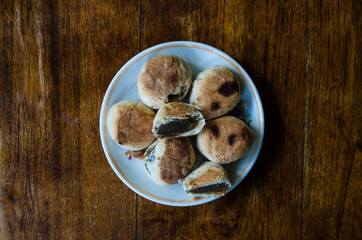 Typical Indonesian sweets: Bakpia centered on plate from bird's eye perspective.