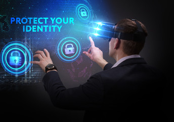 Business, Technology, Internet and network concept. Young businessman working on a virtual screen of the future and sees the inscription: Protect your identity