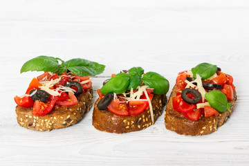 Bruschetta with fresh tomato, basil, cheese and olive