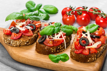 Bruschetta with fresh tomato, basil, cheese and olive