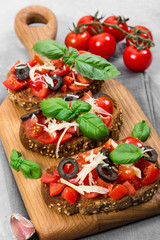 Bruschetta with fresh tomato, basil, cheese and olive