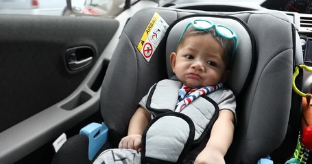 baby sitting in car seat safety driving of family travel road trips