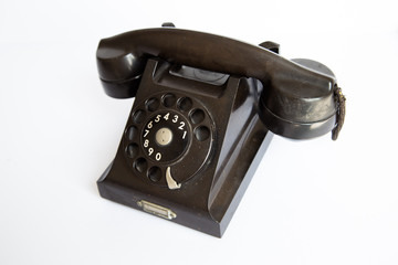 Vintage black rotary dial telephone on white background