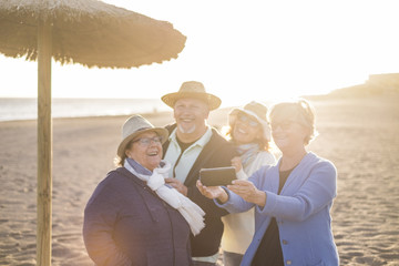 group of friends, elderly and middle age, having fun at the beach